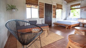 A room with a sofa, a chair, a bed, and a small table. - Buen Camino Hotel, San Mateo (San Mateo)