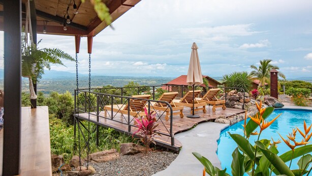 A pool area with lounge chairs and a view of the landscape. - Buen Camino Hotel, San Mateo (San Mateo)