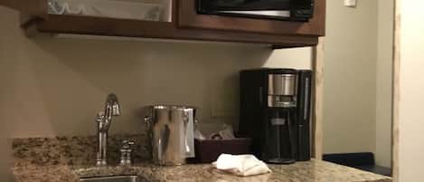 Fridge, microwave, coffee/tea maker, cookware/dishes/utensils
