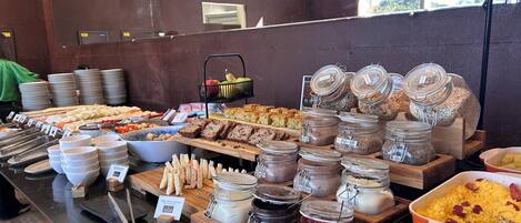 A buffet with various food items and condiments.