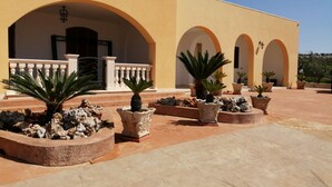 A building with multiple arches and a tiled courtyard.