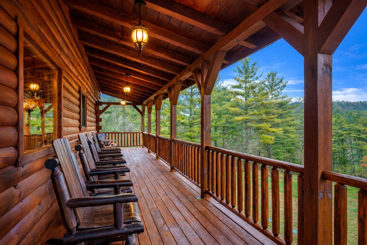 A wooden cabin with a covered porch and a row of benches.