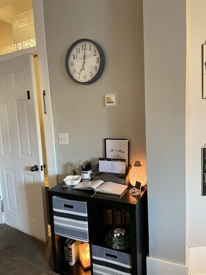 Welcome to K's Place, where a functional desk area invites work or study, and a traditional door adds a touch of classic charm.