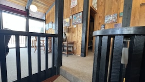 A wooden interior with a wooden staircase, a bench, and a sign indicating a room number. - Classic Chalet on free shuttle route-fireplace, hot tub and sauna.

5 Bedrooms (Snowmass Village)