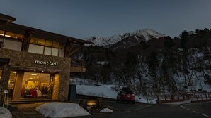 A mountain lodge with a stone facade and a sign reading "mont-bell". - Tabist Sekkasou (Daisen)