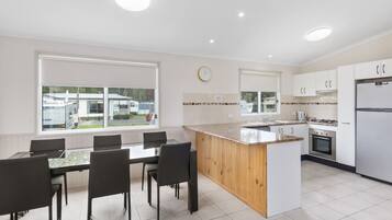 Deluxe 2 Bedroom Cabin | Living area | TV, table tennis