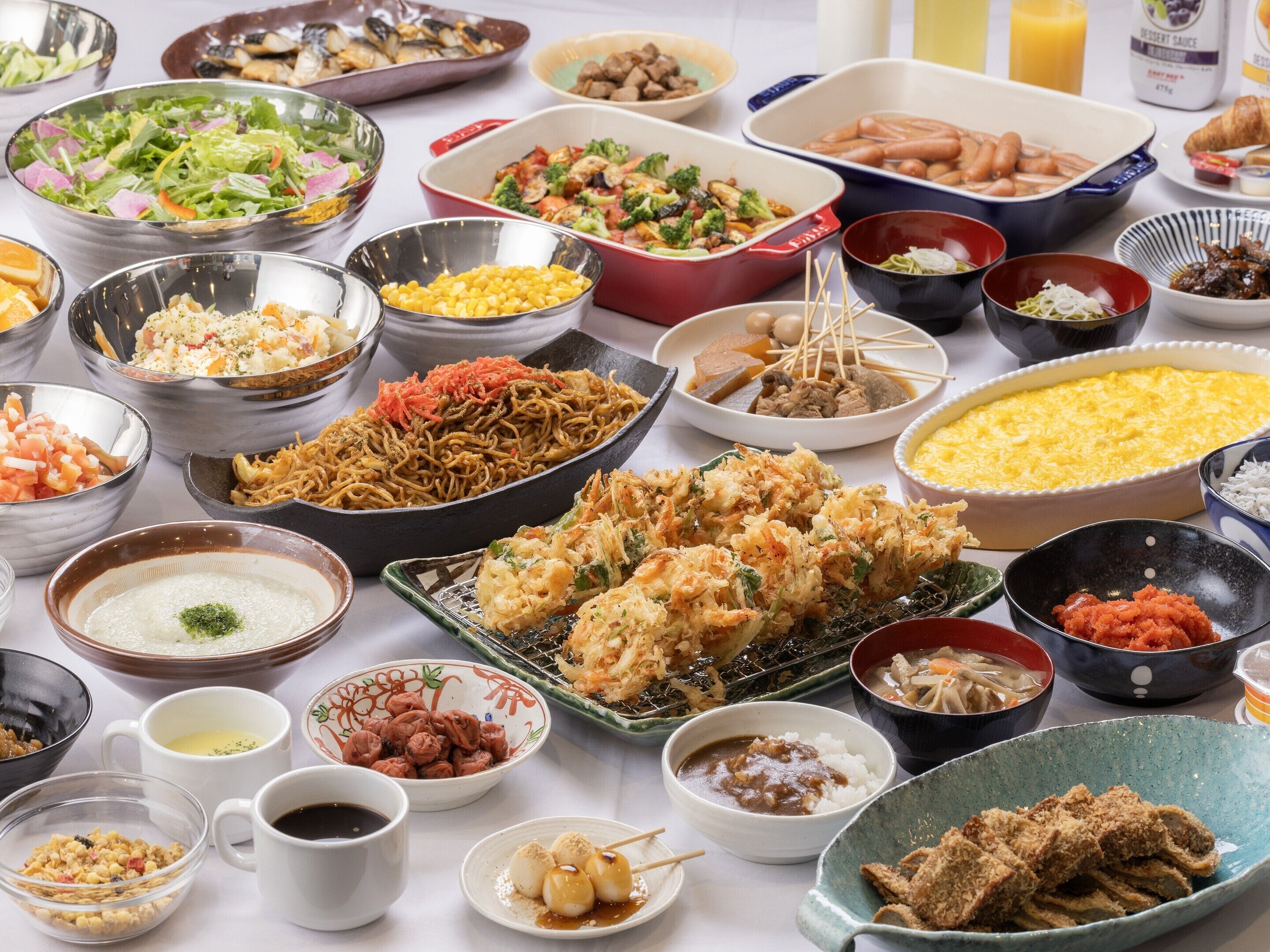 A variety of dishes including noodles, seafood, and rice bowls, suggesting a diverse meal selection.