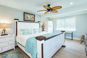 A bedroom with a bed, a ceiling fan, a dresser, a window with blinds, and a framed picture on the wall. - P52 - Canal front, 2 bedroom, 3 bath with private pool and dockage (Marathon)