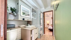 A compact bathroom with a sink, mirror, and toilet. - TERRATHELY, sea view, private pool, walking distance to beach. (Le Moule)