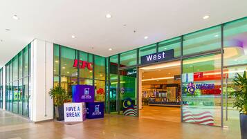 A KFC and West store entrance with glass walls, a 'Have a Break' sign, and Malaysia Madani signage.