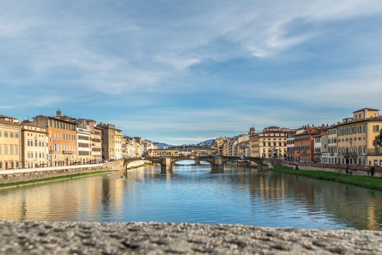 A river with a bridge and buildings on both sides.
