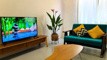 Signature Apartment | Living area | 40-inch Smart TV with digital channels, TV, Netflix
