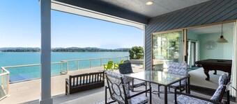 Peaceful lakefront home with firepit, hot tub, pool table, dock, balcony, & deck
