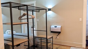 A room with a bunk bed, a ceiling fan, a wall-mounted heater, and a small rug. - Contemporary Style  (Florence)