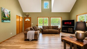 A spacious living room with a high ceiling, wooden flooring, and large windows. - Farmhouse In Plain 2 Bedroom Home by NW Comfy Cabins by RedAwning (Leavenworth)