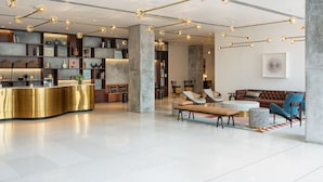 A modern lobby with a reception desk, seating area, and decorative lighting. - Greenpark Bengaluru (Bengaluru)