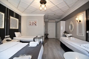 A hotel room with a large bed, a smaller bed, a desk, and a bathroom. - Nova City Hotel (Istanbul)