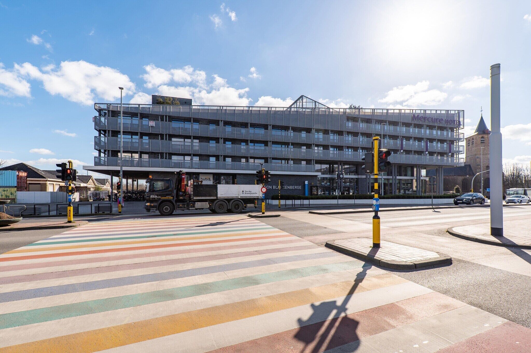 A multi-story building with a modern design, featuring a prominent sign for 'Mercure Hotel'.