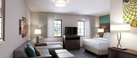 A hotel room with a sofa, a bed, a TV, and a desk.