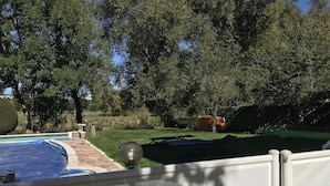 A backyard with a swimming pool, a covered patio area, and a lawn. - Les Pieds dans l'eau with swimming pool and Meuse riverfront (Belleray)