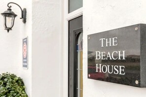 A sign that reads "The Beach House" mounted on a wall. - The Beach House Luxury Rooms (Weston-super-Mare)
