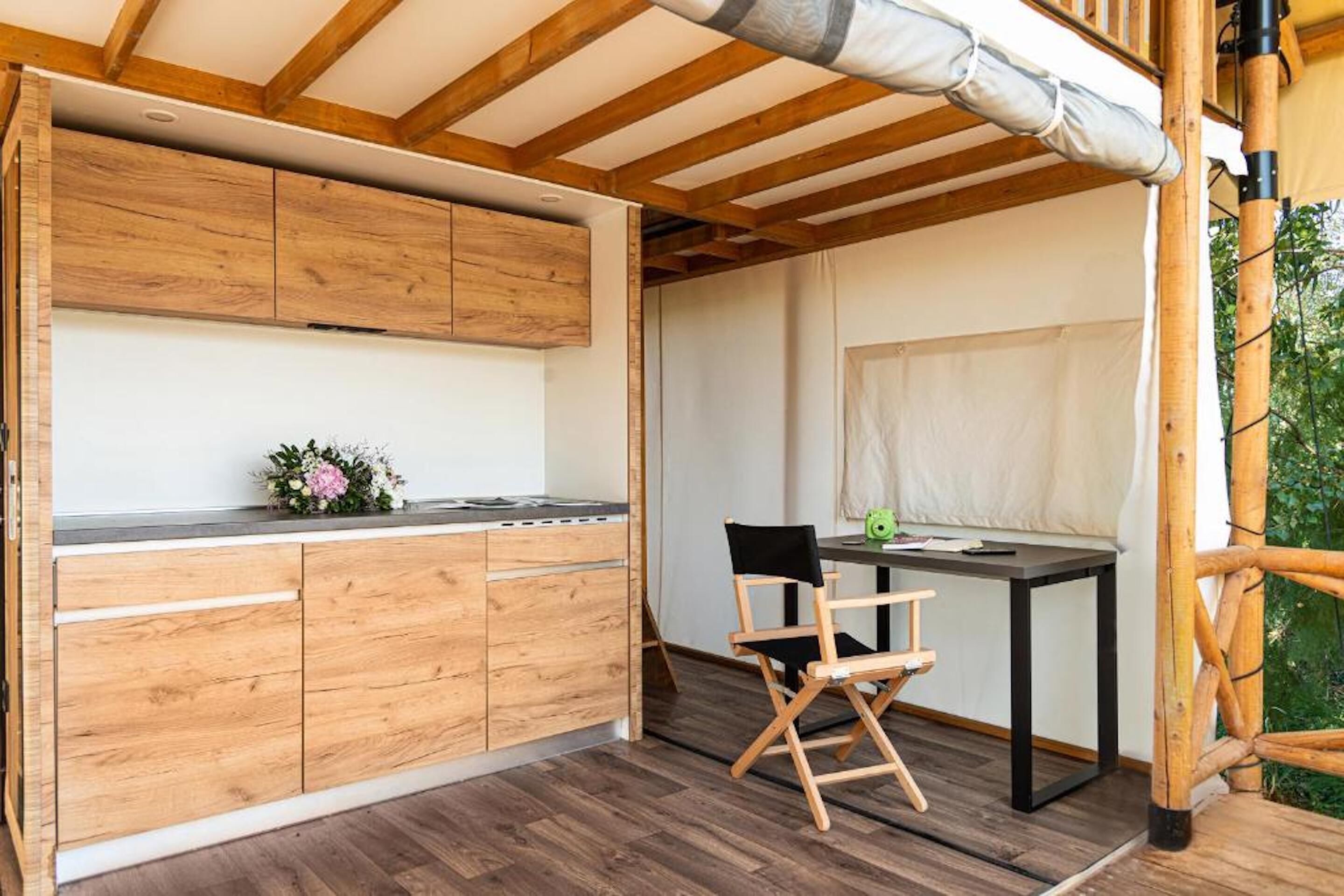 A wooden kitchen with a dining area, including a table and chairs.