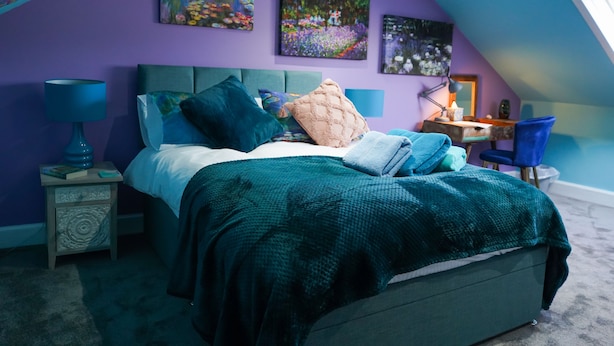 A bedroom with a bed, nightstands, a desk, and a chair. - The Art Bank (Dalbeattie)