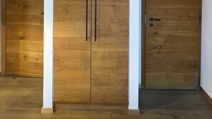 A room with a large wooden wardrobe, white walls, and wooden flooring. - Auberge de l'Union Arzier (Arzier)