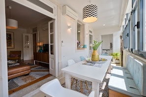 A modern interior with a dining area, a living room, and a kitchen.