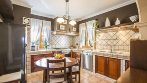 A kitchen with a dining table, chairs, a refrigerator, a dishwasher, and a sink. - ES CAMP FRED -  beautiful villa with spectacular private pool and impressive garden. Free (Felanitx)