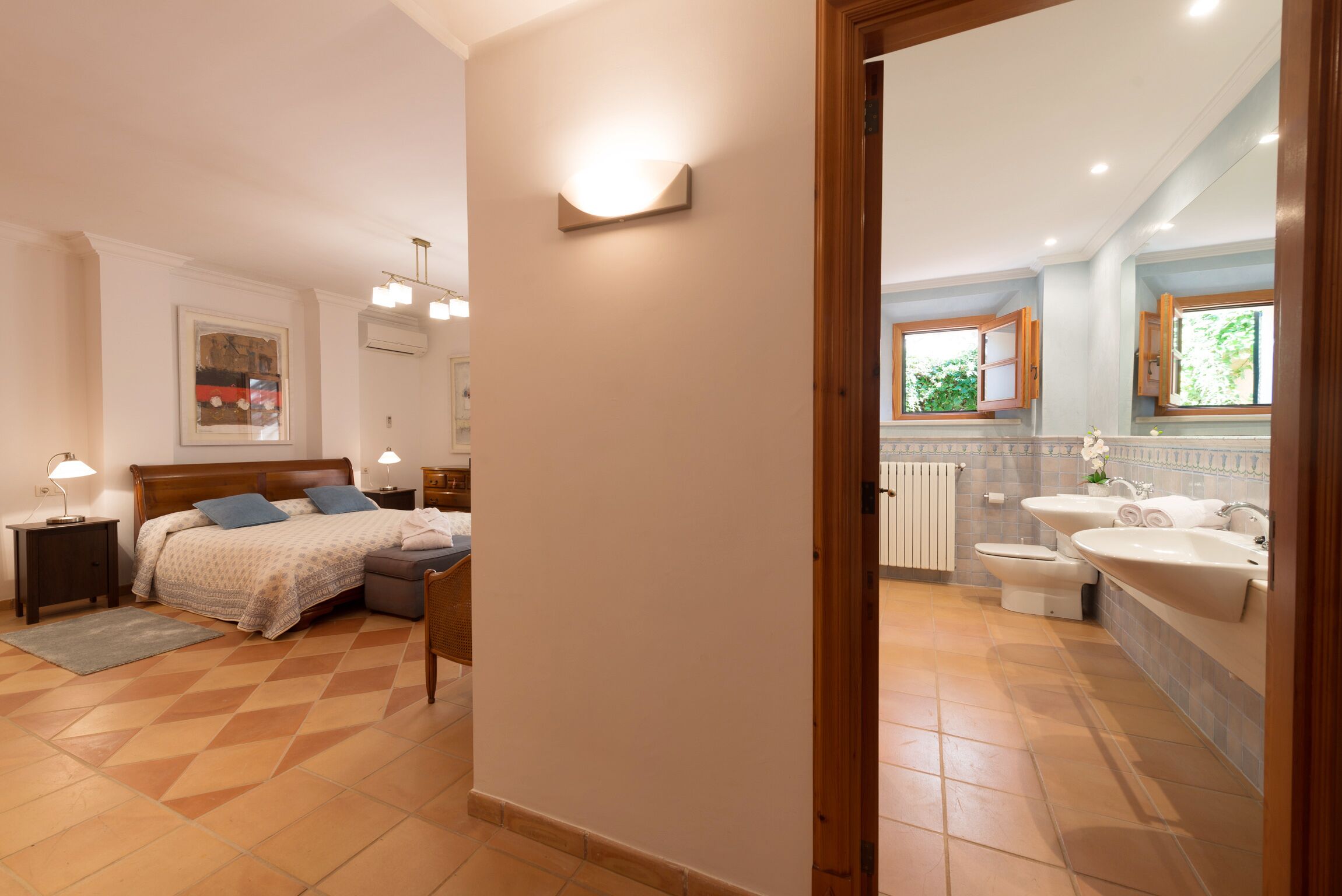 A bedroom with a bed, bedside tables, and a nightstand.