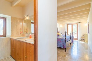 A bathroom with wooden cabinets and a large mirror. - CAN RITO - Villa with private pool in FELANITX. Free WiFi (Felanitx)