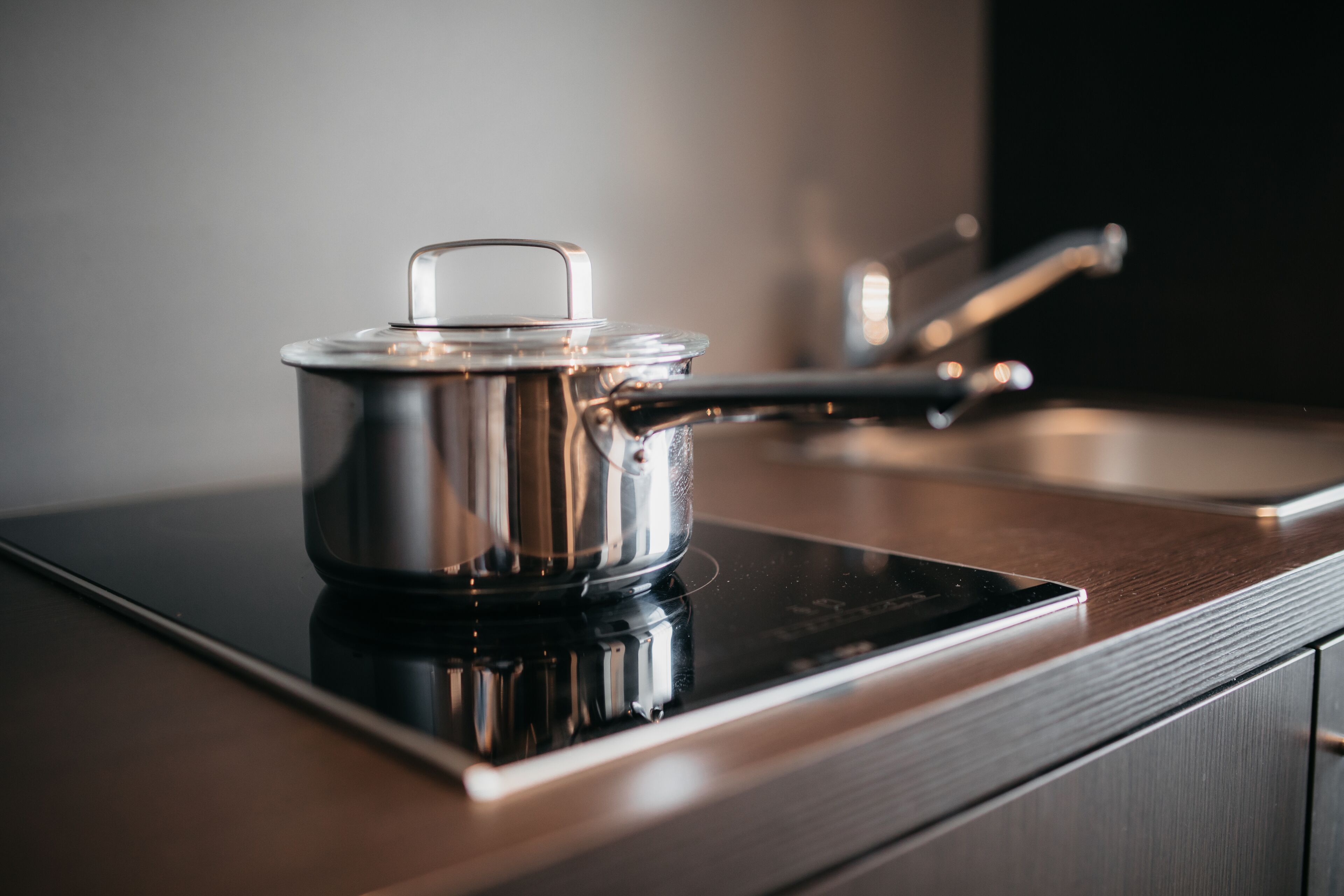 A stainless steel pot on an induction cooktop.