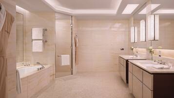 A modern bathroom with a glass-enclosed shower, a double sink vanity, and a large mirror.