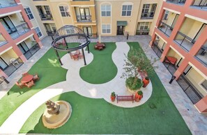 Relax in the serene courtyard, surrounded by lush greenery and a tranquil gazebo.