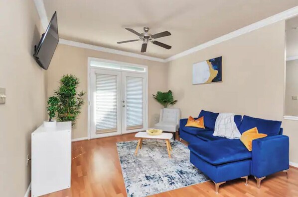 Relax in this stylish living room with a sofa, coffee table, and flat-screen TV.