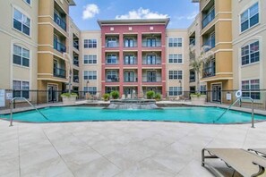 Enjoy a refreshing swim in the central courtyard pool surrounded by comfortable lounge chairs.