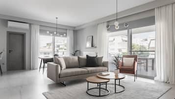 Departamento Deluxe | Área de sala de estar | Televisión de 43 pulgadas con canales digitales, chimenea y Netflix