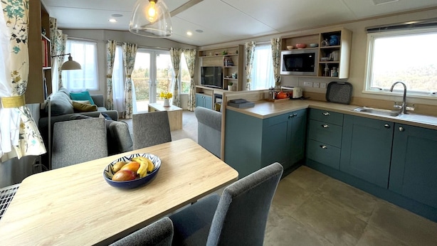 A compact living space with a dining area, kitchenette, and seating area. - Beautiful 2BR In Kippford With Incredible Views - Pass the Keys (Dalbeattie)