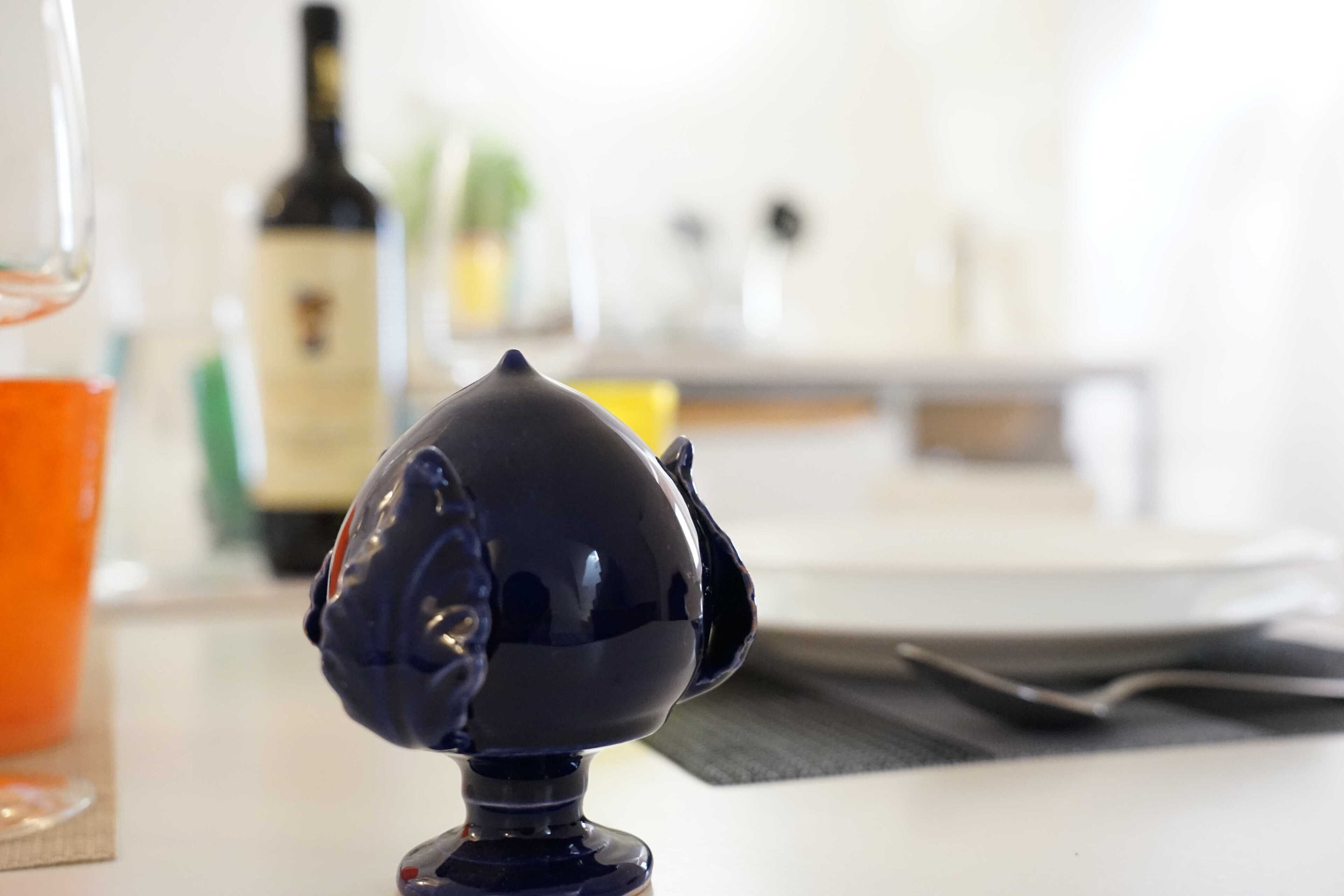 A close-up of a dark blue object on a table with a blurred background.