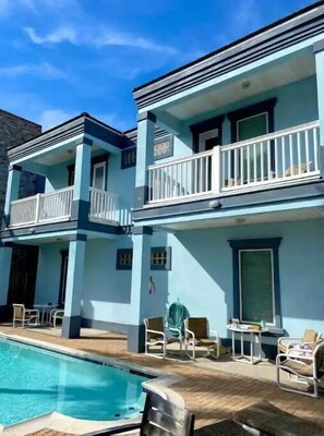 Enjoy poolside relaxation with a balcony overlooking the pool.
