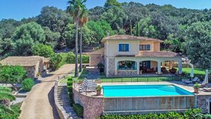 A two-story villa with a swimming pool, surrounded by lush greenery and hills. - Country House 'Es Pujols' with Private Pool, Private Terrace and Wi-Fi (Artá)