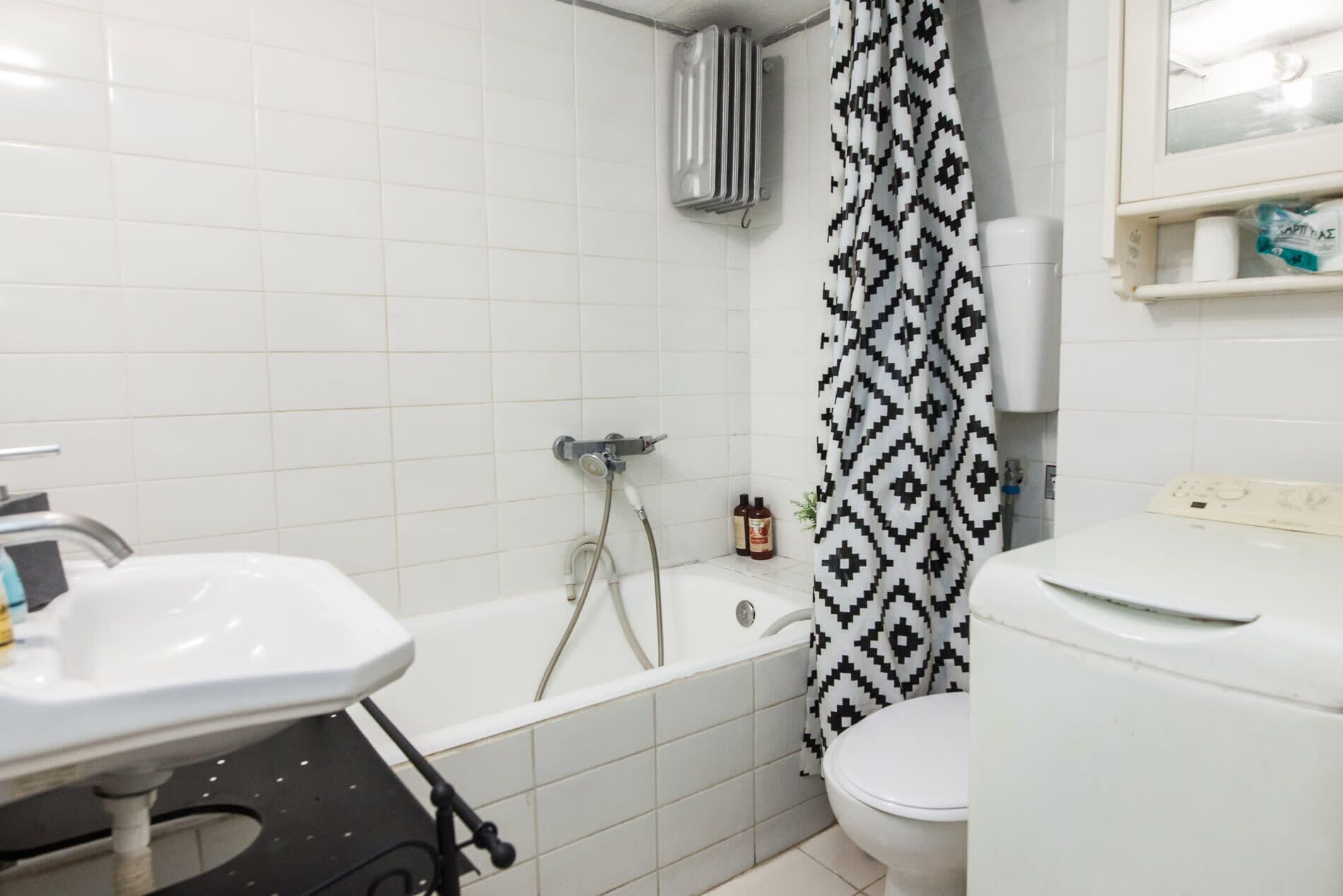 A bathroom with a bathtub, toilet, and sink.