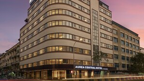 A multi-story hotel with a curved facade, large windows, and a prominent signage indicating it is the Aurea Central Hotel. - Aurea Central Hotel (Phnom Penh)