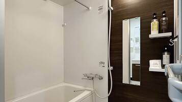 Bathtub, hair dryer, towels, soap