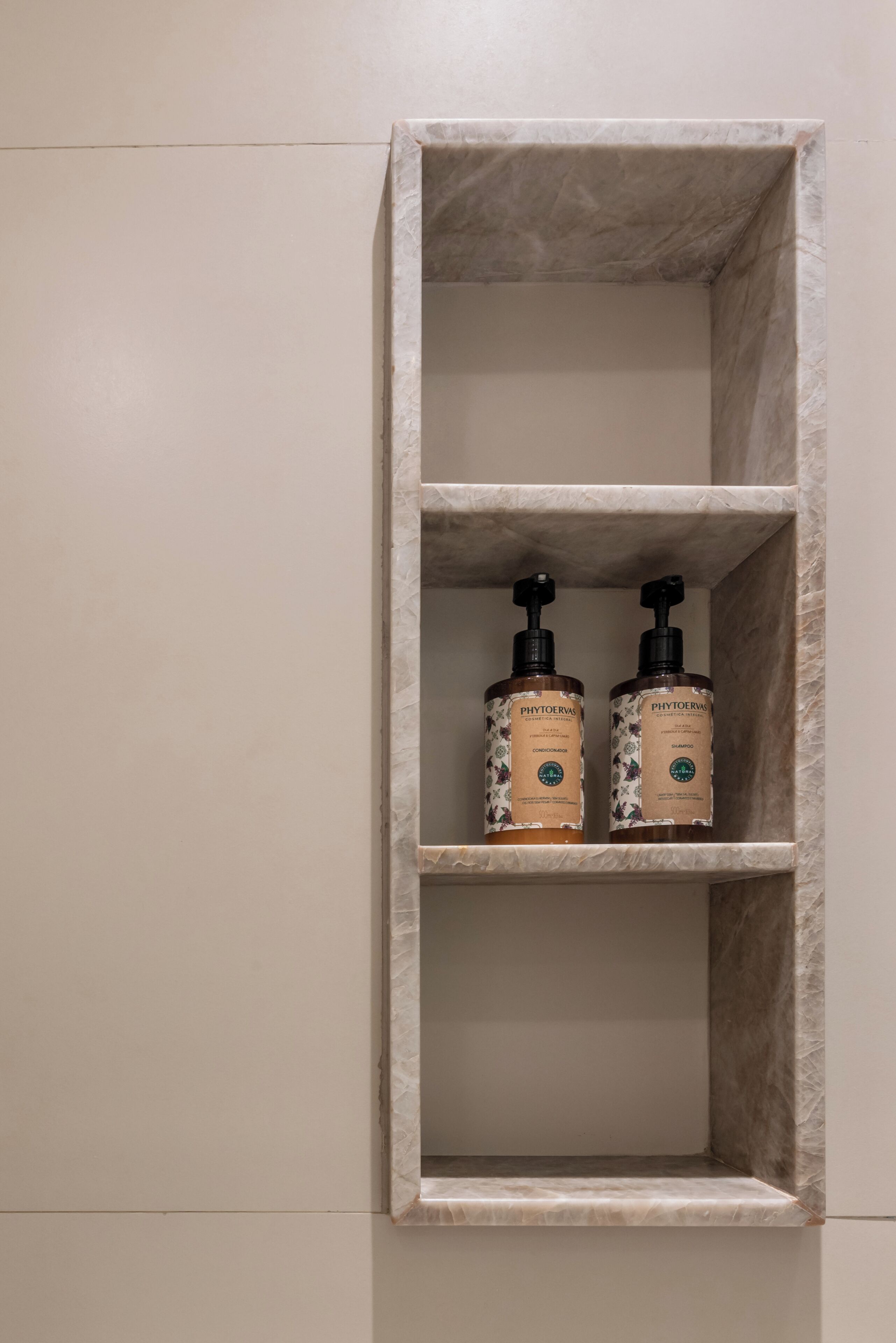 A marble shelf with two bottles of Phytoverwa hair care products.