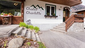 Un bâtiment sur lequel on peut lire l’inscription « Chalet Charlotte », et un escalier en bois menant à l’entrée.