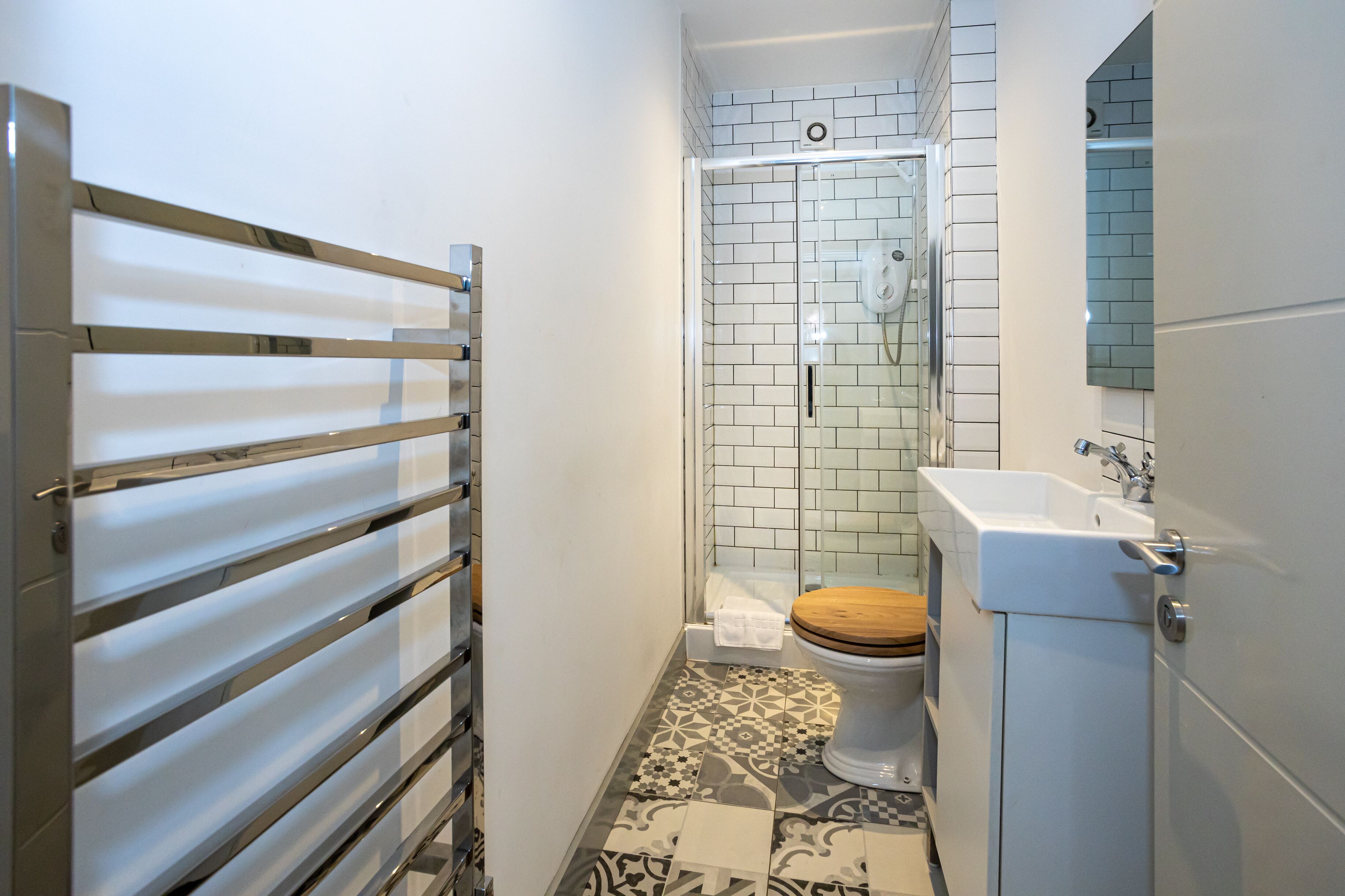 A bathroom with a shower, toilet, and sink.