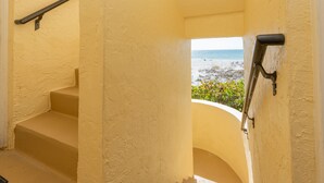 A staircase with a view of the ocean. - Anna Maria Island Direct Beachfront Condo- Awesome View and Amazing Sunsets (Holmes Beach)