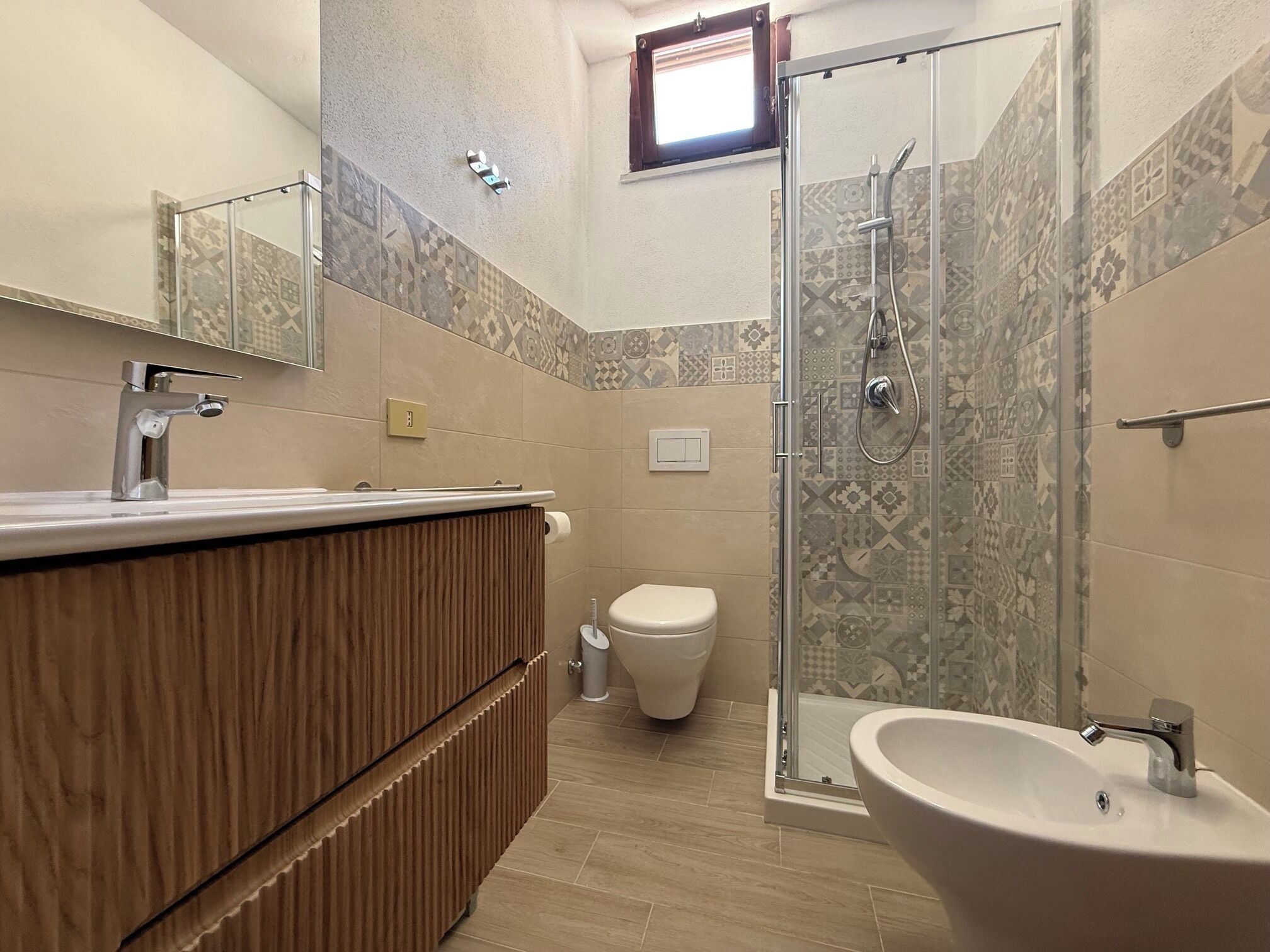 A bathroom with a shower, toilet, and sink.